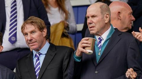 Eric Eisner and Michael Eisner in the stands at Portsmouth FC