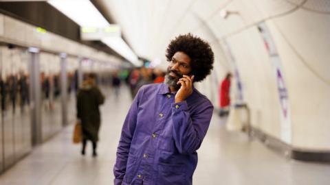 man on phone on elizabeth line