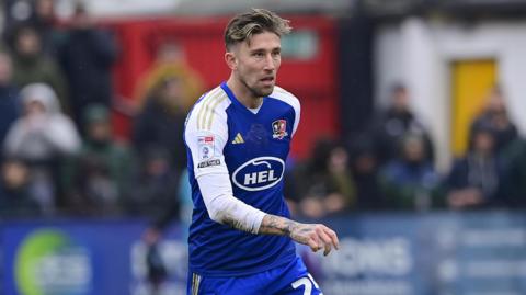 Angus MacDonald on the ball for Exeter City