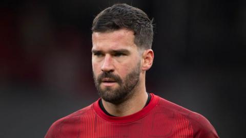 Liverpool keeper Alisson looks on during a match