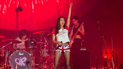 Olivia Rodrigo singing on stage at Glastonbury