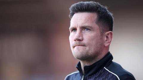 Crewe boss Lee Bell watches on from the touchline