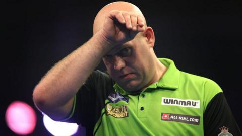 Michael van Gerwen looks disconsolate after his defeat by Ryan Joyce