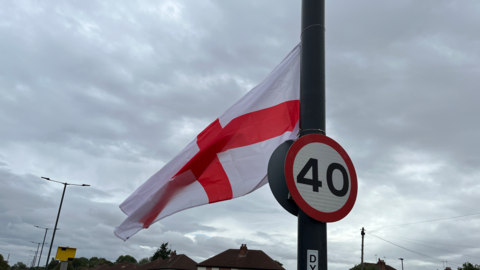 St George flag attached to a lamp post in Alvaston, Derby