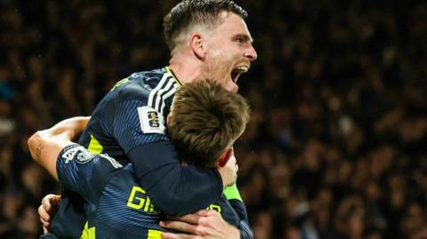 Andy Robertson hugs Billy Gilmour