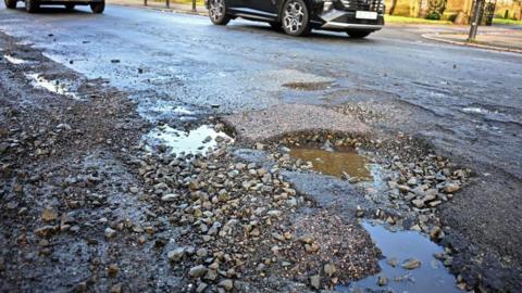 Potholes in road