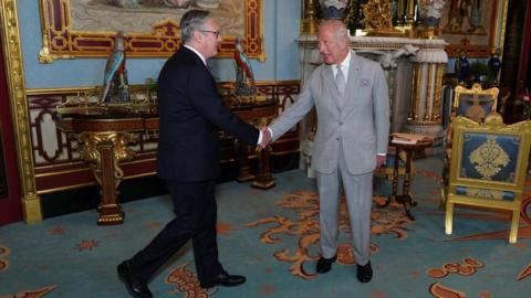 Keir Starmer and King Charles shake hands