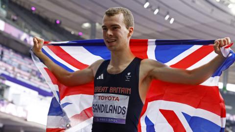 Ben Sandilands celebrates with a Great Britain flag