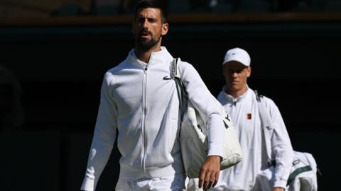 Novak Djokovic and Jannik Sinner walk out