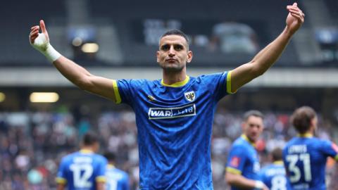 Omar Bugiel celebrates scoring for AFC Wimbledon against MK Dons