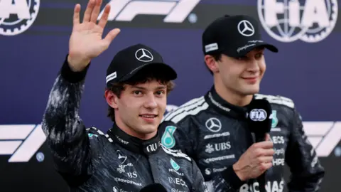 Fans dressed in Ayrton Senna race overalls and helmets at the Japanese Grand Prix