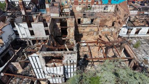 An aerial view of the old Raven Hotel in Droitwich - showing the roof blown off the building and piles of rubble on the floor.