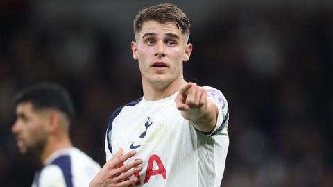 Micky van de Ven points at his team-mates while playing for Tottenham in a Champions League game