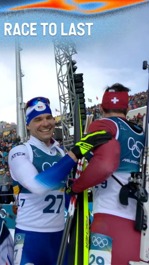 France's Fabien Claude smiles holding ski's after Biathlon 15km