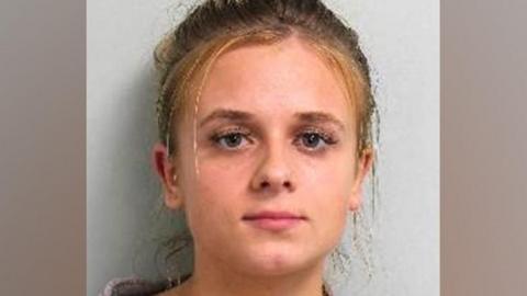 Custody image of Roksana Lecka. She is looking directly at the camera wearing a woollen type cardigan.