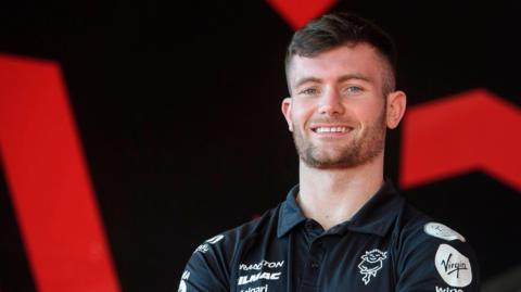 Josh Honohan with his arms folded as he is unveiled as a Lincoln City player