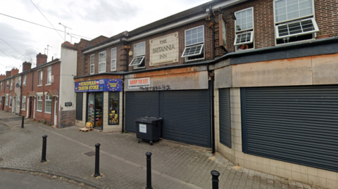 A row of two shops on a residential terraced street in Rotherham 
