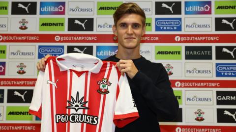 New Southampton signing Elias Jelert holds the Southampton shirt after joining