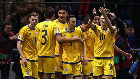 Kazakhstan players celebrate scoring against Belgium