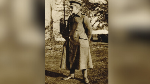 An archive sepia image of Lieutenant Osmond Bartle Wordsworth. He is wearing a uniform and an overcoat outside.