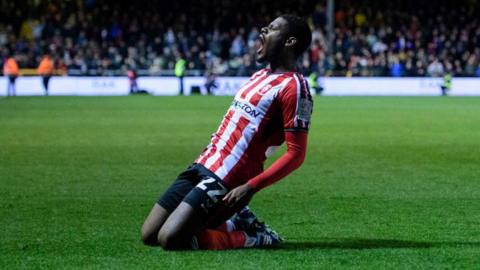 Lincoln defender TJ Eyoma celebrates scoring a goal