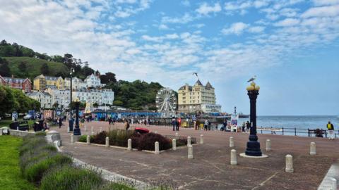 Light cloud over the coast and pier at Conwy. 