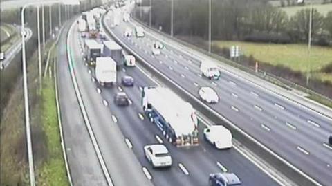 A series of vehicles on the M25 motorway.