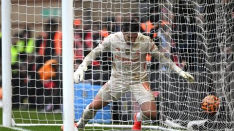 Manchester City goalkeeper Stefan Ortega ends up in the net  following Leyton Orient's extraordinary FA Cup opener