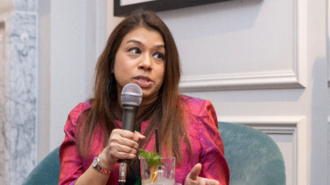 Tulip Siddiq pictured holding a microphone at an event in 2023