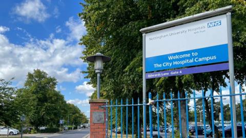 Entrance to City Hospital in Nottingham with fence and sign