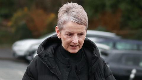 Lady Donaldson, a woman with grey hair, wearing a black coat and black top.