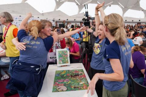 A team celebrates completing their puzzle