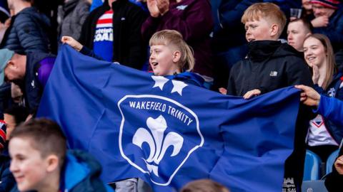 Wakefield Trinity fans cheer on their team ahead of kick-off