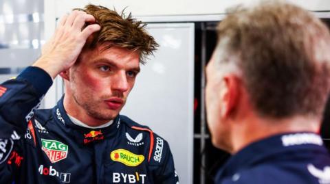 Max Verstappen speaking to Red Bull team principal Christian Horner at the Singapore Grand Prix