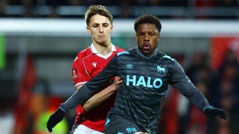 Wrexham's Max Cleworth (left) challenges Ipswich Town's Chuba Akpom