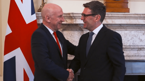 John Healey and Andy Burnham shake hands