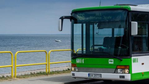 A local bus numbered 666, heading to Polish seaside resort Hel, is parked on the roadside in Rewa, Poland.
