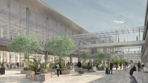 Artist’s impression of the proposed expanded London Luton Airport terminal, showing passengers in a bright concourse with shops, trees, glass walkways and an aircraft taking off above.