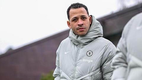Liam Rosenior in Chelsea's training kit looking across the pitch at the training ground