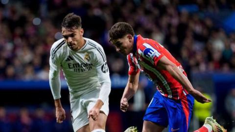 Atletico Madrid and Real Madrid in action
