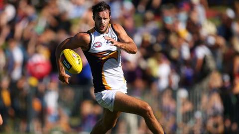 Mitch Brown of the West Coast Eagles runs onto the ball during an AFL match between the Fremantle Dockers and the West Coast Eagles at Arena Joondalup on 18 February 2014 in Perth, Australia.