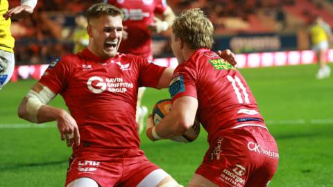 Wales autumn squad members Taine Plumtree and Blair Murray celebrate a Scarlets score