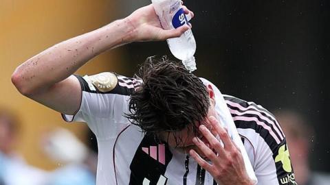 Juventus player Nicolo Savona pours water on his head during a Club World Cup game