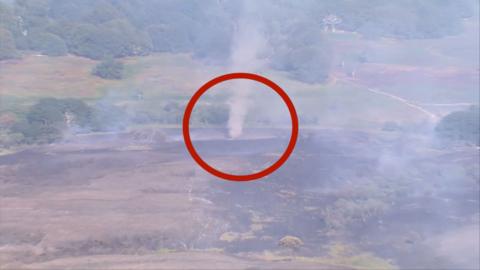 Aerial footage from a helicopter shows a dust devil in the distance over New Forest, Hampshire.