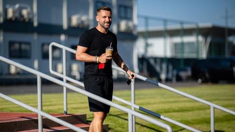 Manchester United defender Luke Shaw on the steps at Carrington