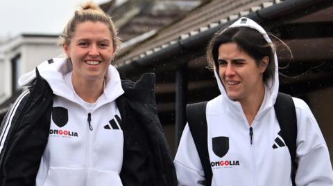 Ellie Olds and Megalie Mendes walk before a match