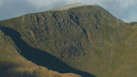 A general view of the east side of the Helvellyn range. The steep slope on the right is the final climb up from Striding Edge. A zoom shot from Fairfield.