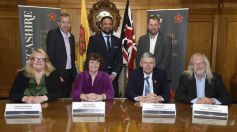 An image of the leaders involved in the new authority, smiling alongside their name-plates