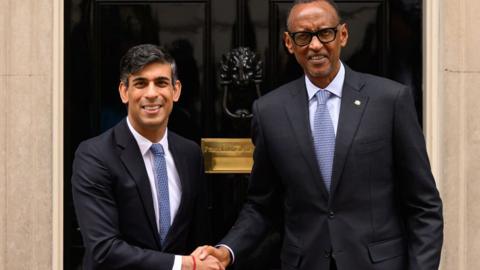 Rwandan President Paul Kagame (R) is greeted by Britain's Prime Minister Rishi Sunak (L) as he arrives at Downing Street on April 09, 2024. 