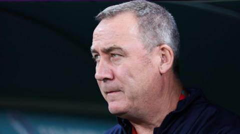 Rene Meulensteen stood in the dugout looking pensive